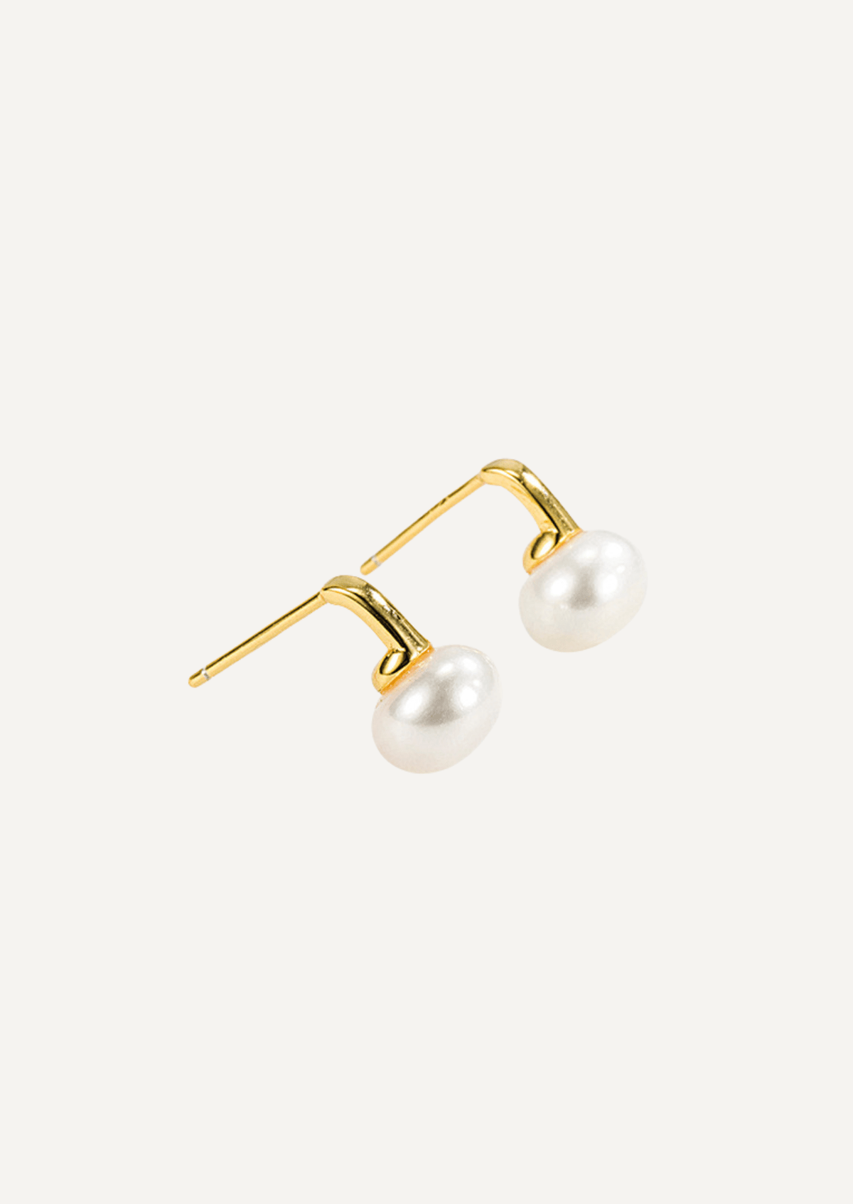 Angled view of Selene gold vermeil freshwater pearl earrings showing their post fittings