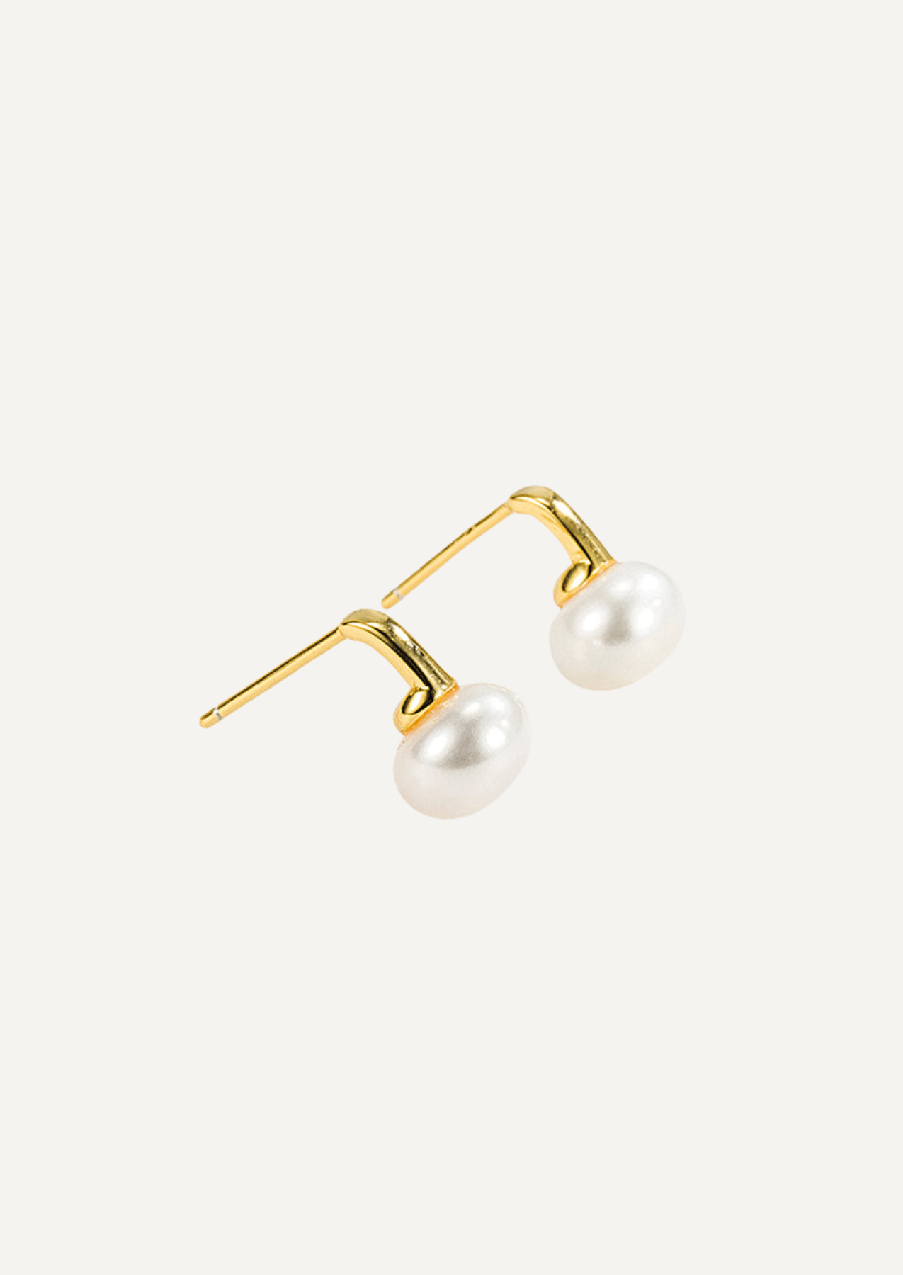 Angled view of Selene gold vermeil freshwater pearl earrings showing their post fittings