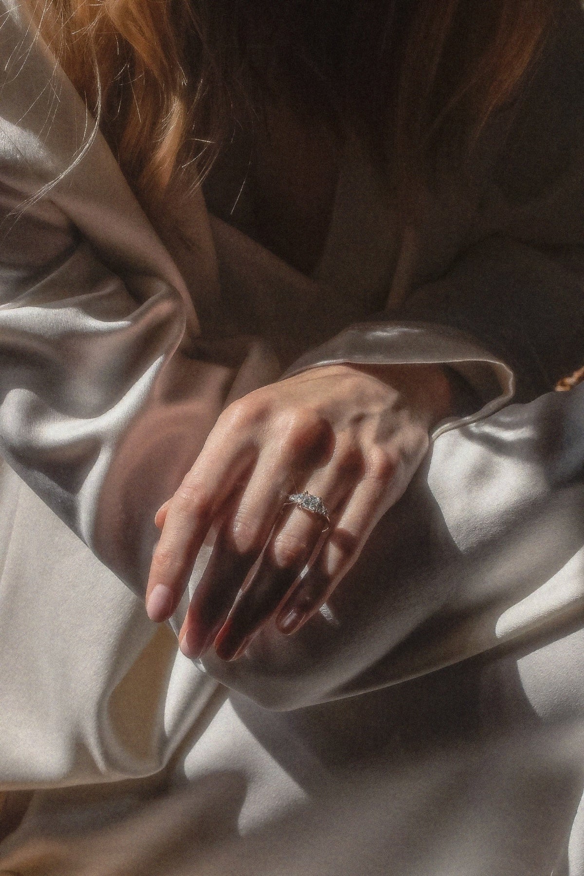 The Vera ring worn on the hand in an editorial view, showing its five-stone rhythm