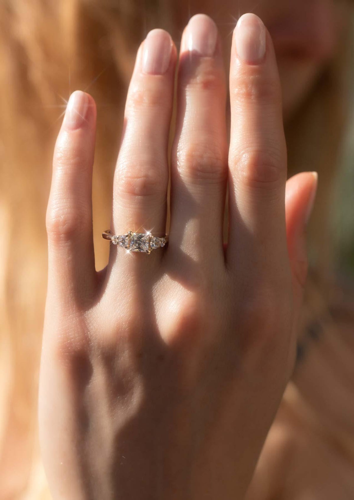 The Vera five-stone ring worn on the hand, showing its graduated span