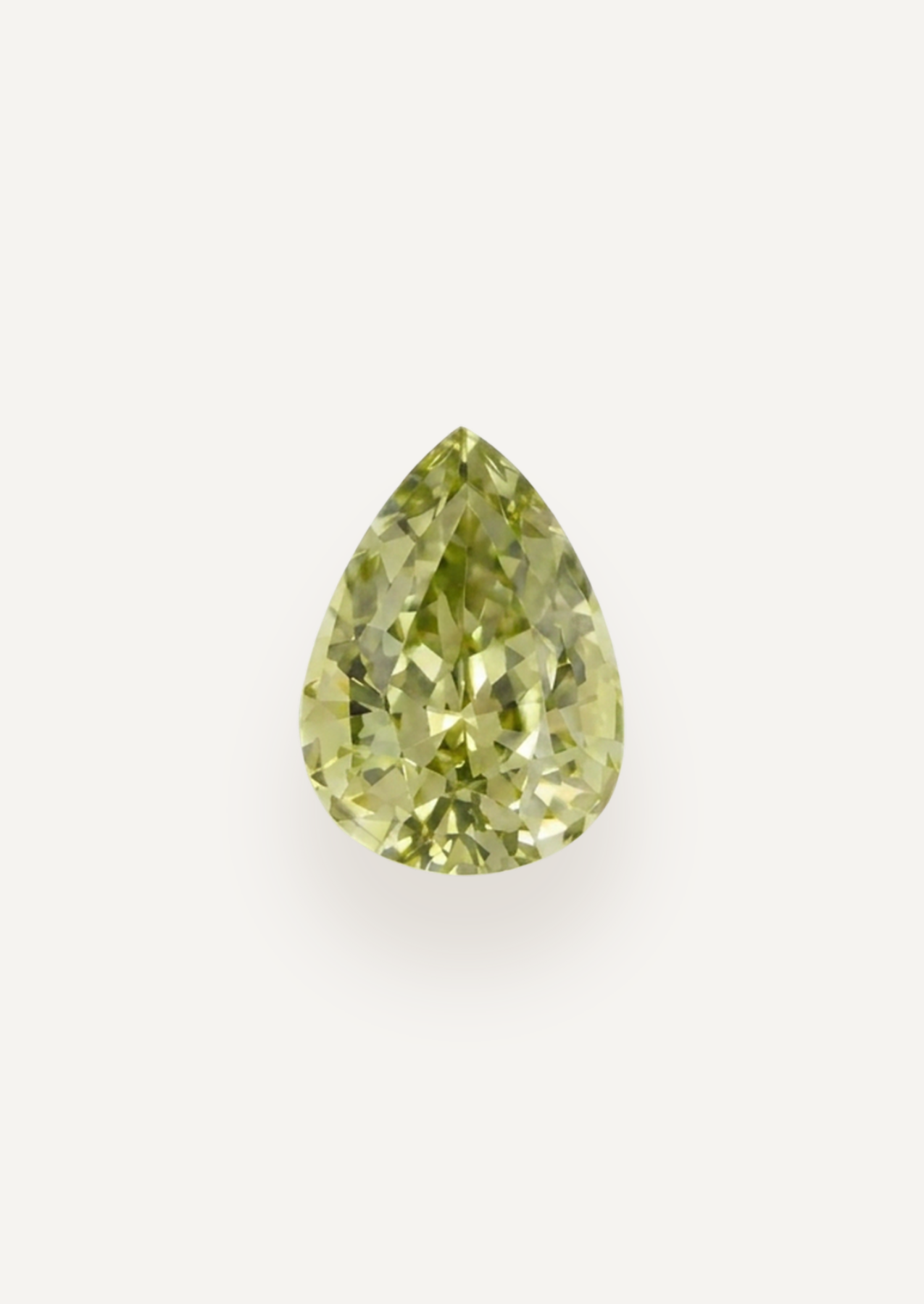 Face up product view showing pale yellow green in a tapered drop with scattered dark marks.