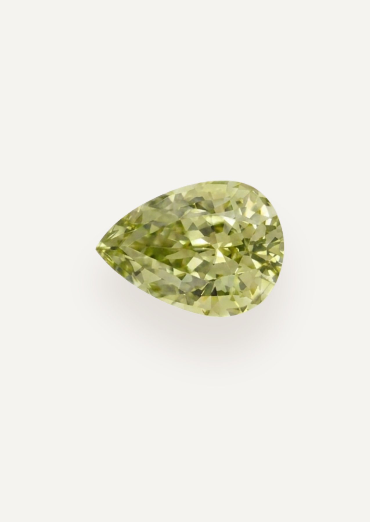 Alternate face up product view showing pale yellow green in a tapered drop with scattered dark marks.