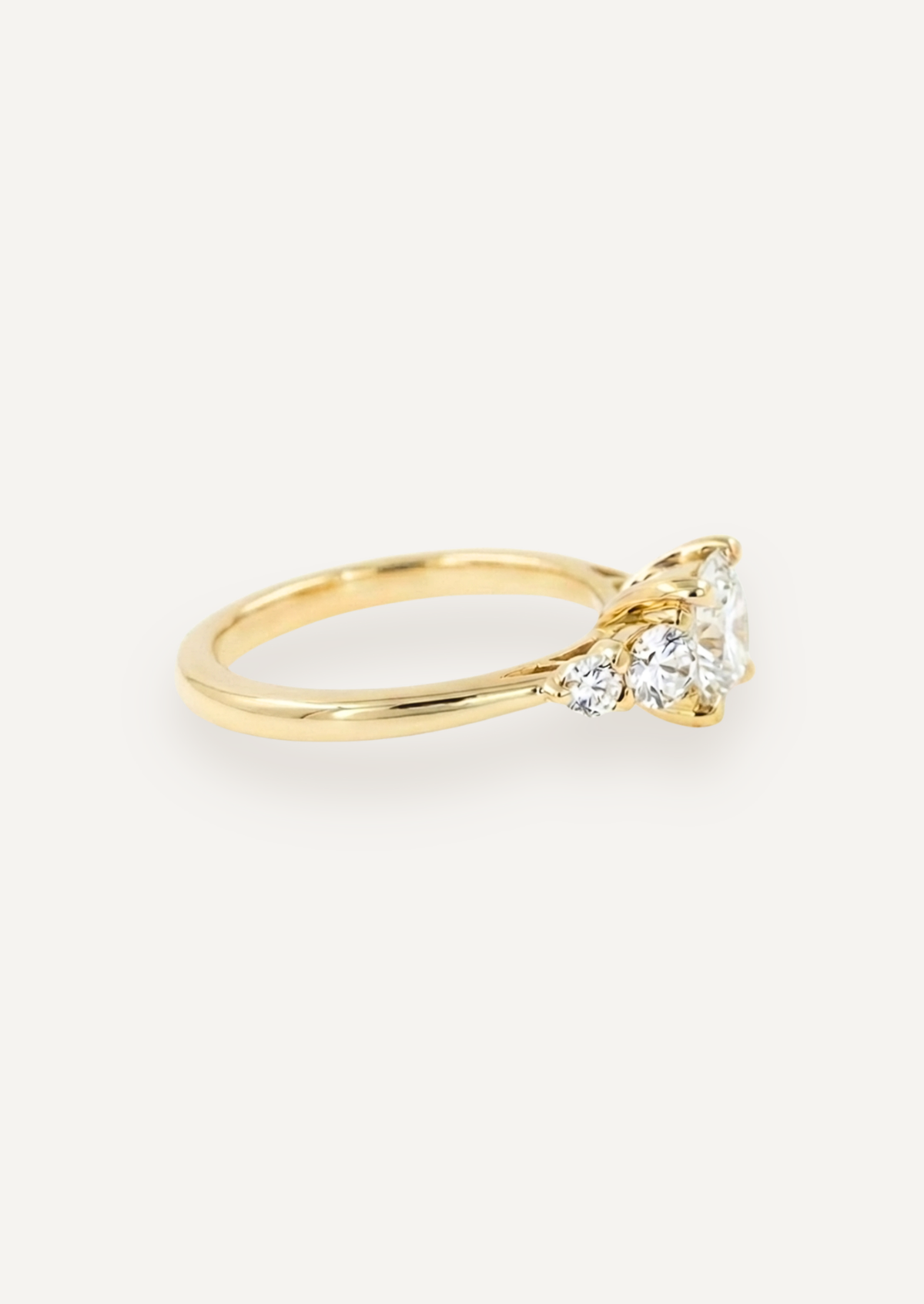 Side profile of the Vera five-stone ring, showing the raised centre setting and graduated shoulders