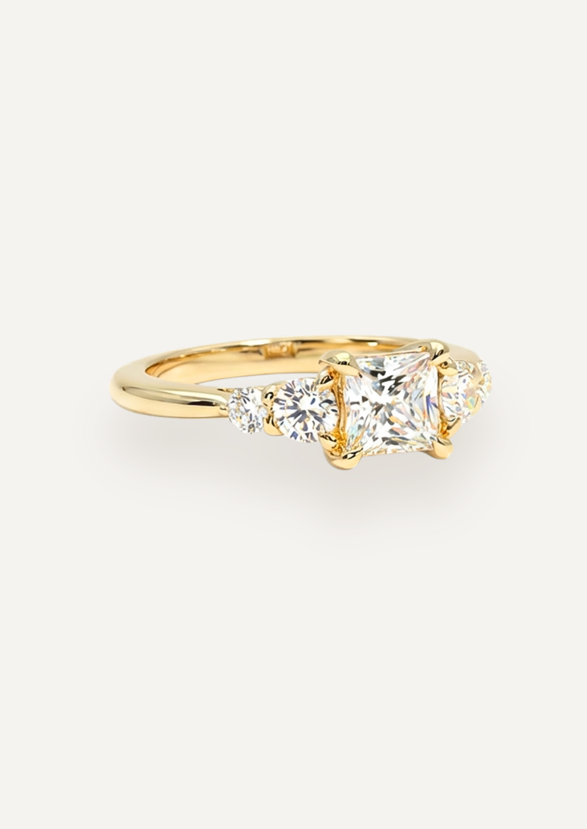 Three-quarter view of the Vera five-stone ring, showing the princess-cut centre and graduated side stones