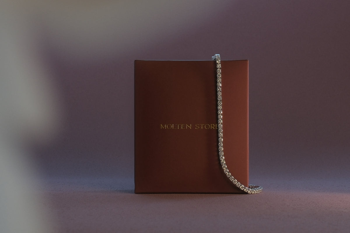 Brown Molten Store packaging with a jewellery chain draped across it.