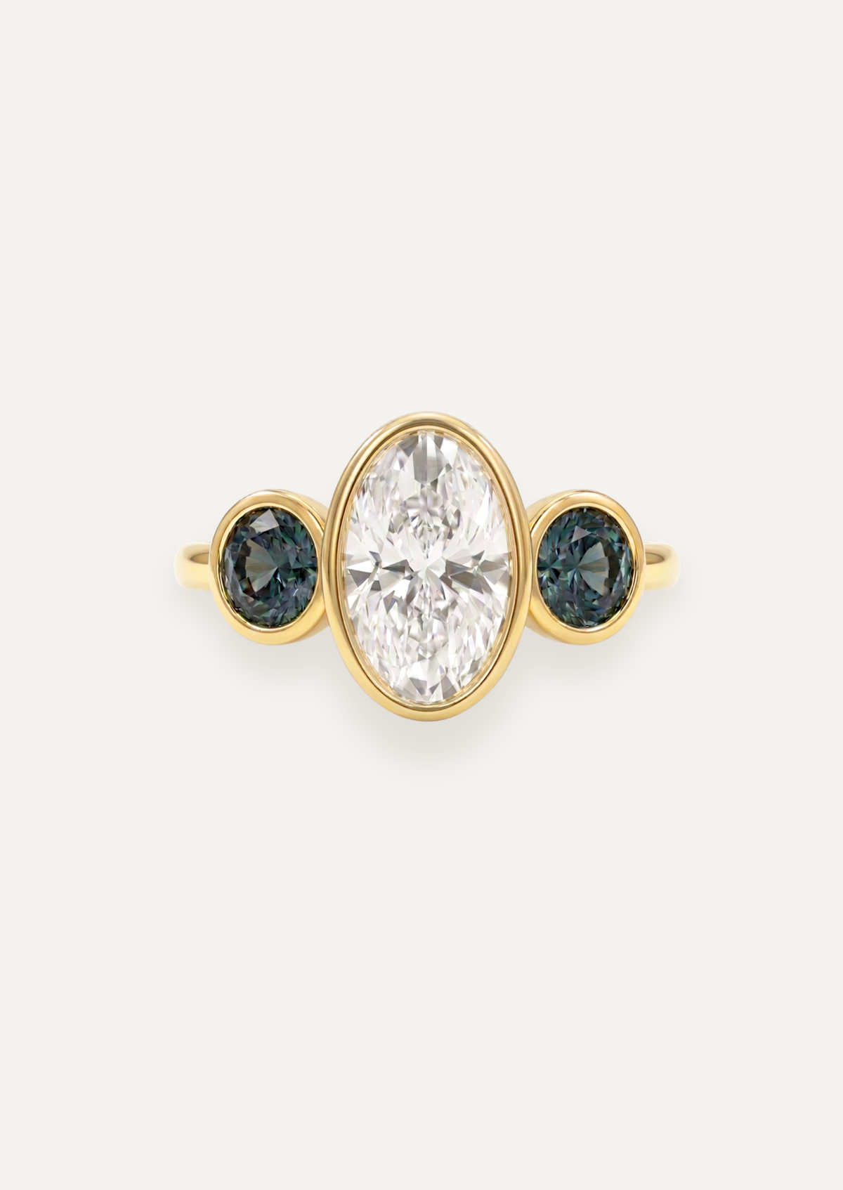 Front render of The Beatrice Ring with a white diamond centre and green sapphire side stones in 18ct yellow gold.