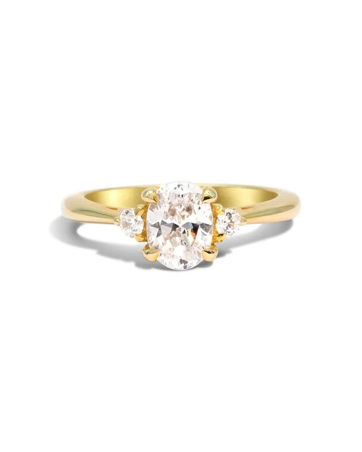 Yellow gold, white diamond, three stone engagement ring with four claws on the centre stone and three on each side stone