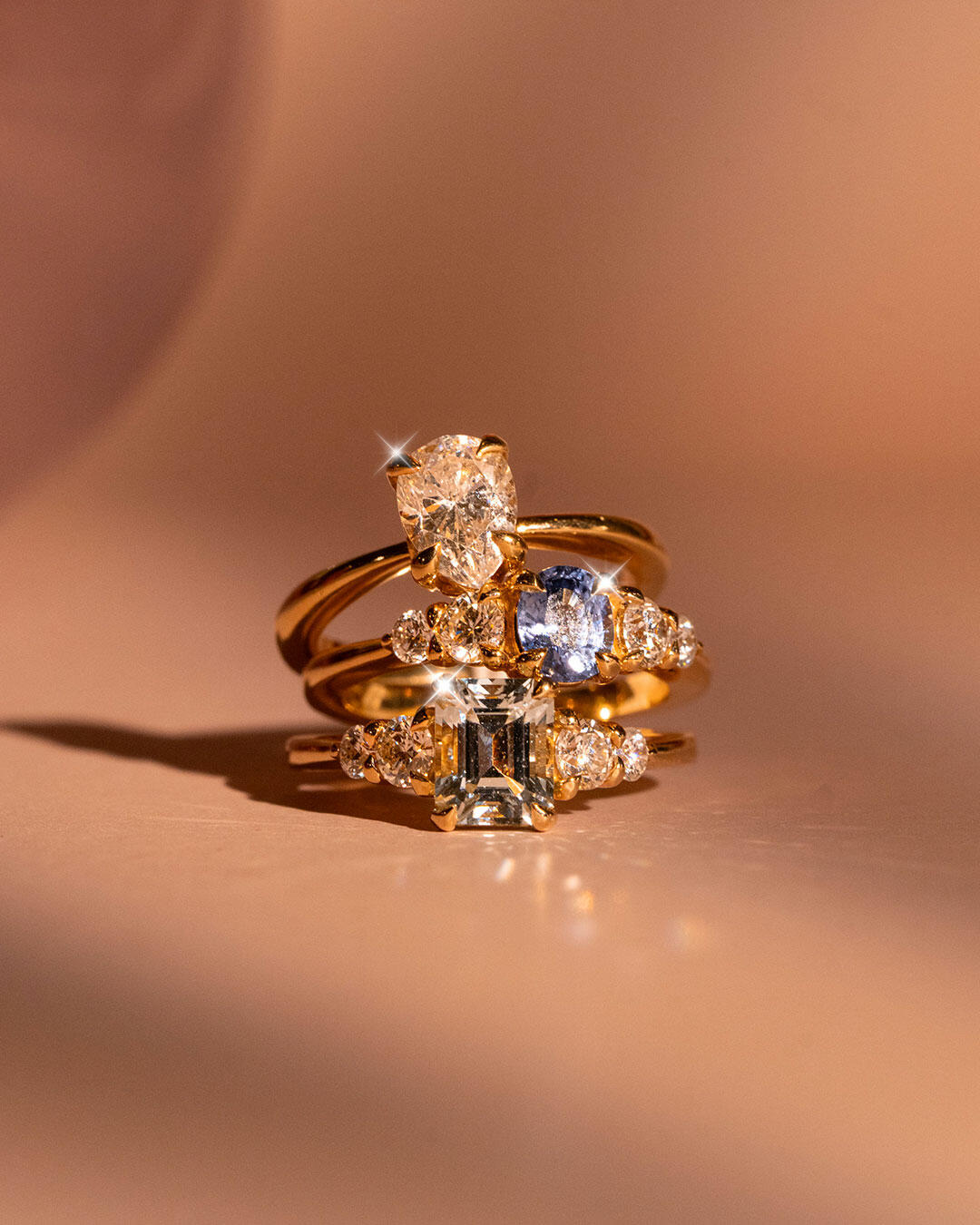 Three engagement rings sitting in a stack