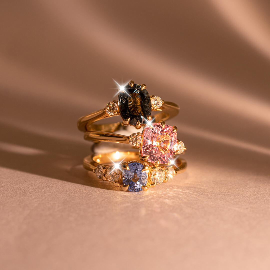 Image of an engagement ring with an oval centre stone and 3 side stones on each side scaling down