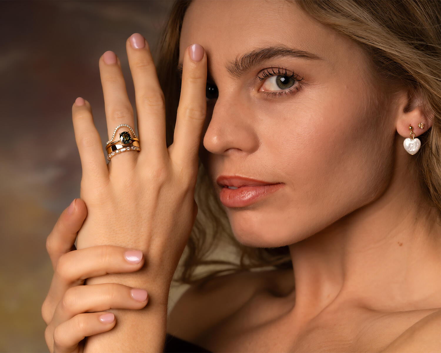 Image of an engagement ring with an oval centre stone and 3 side stones on each side scaling down